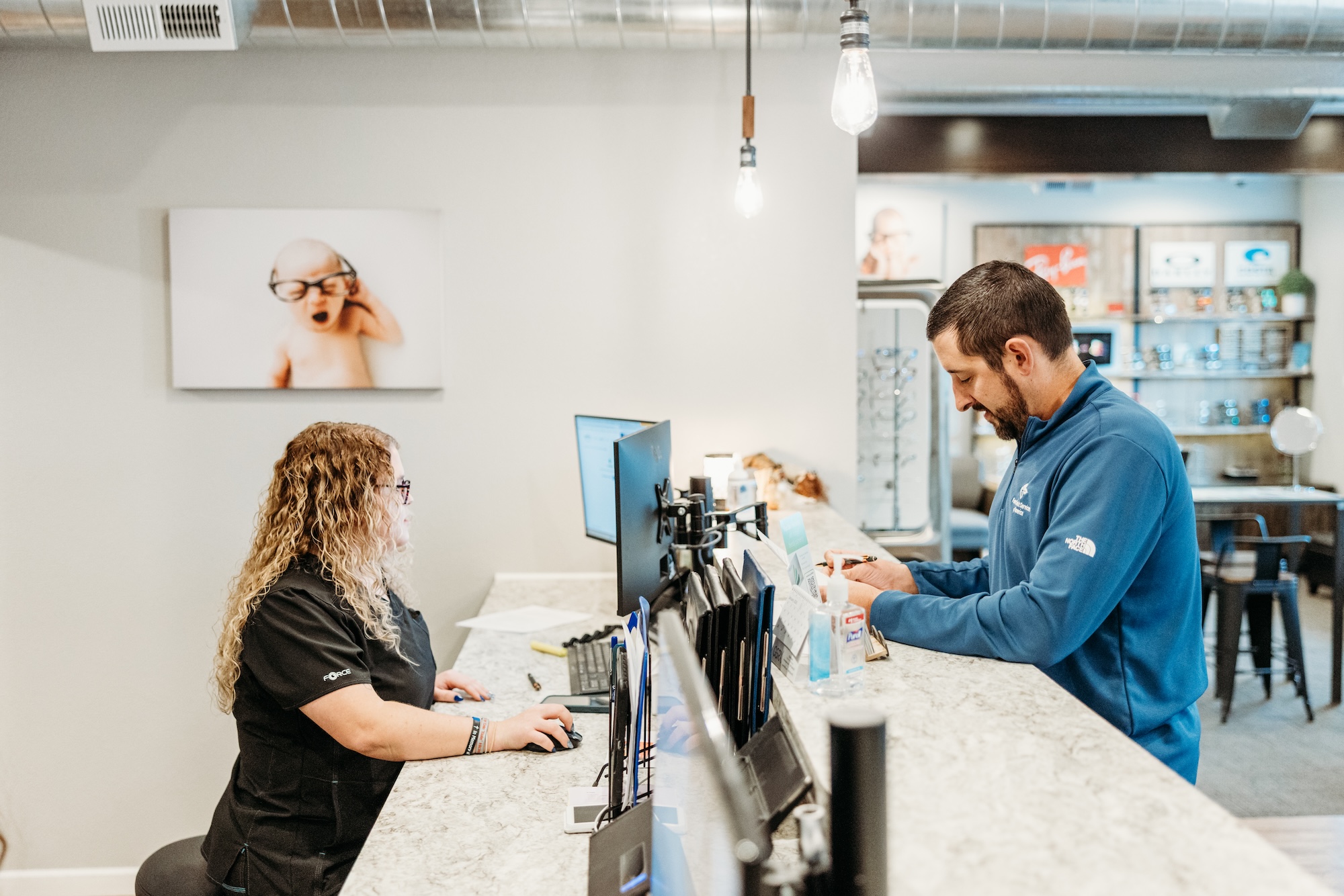 Photo of a patient getting help at the front desk